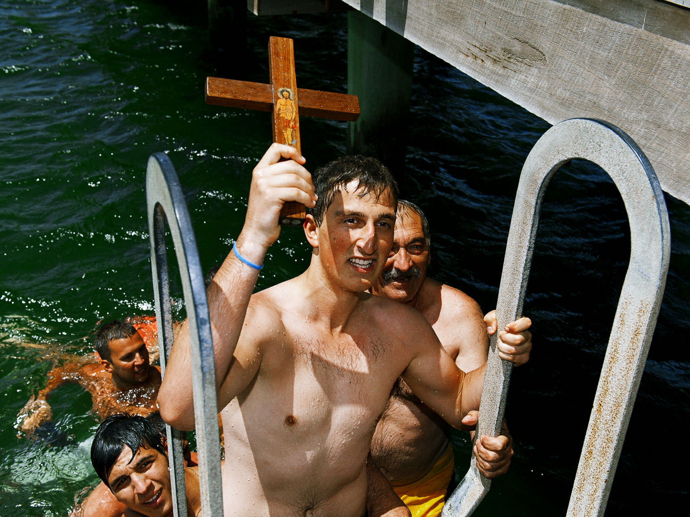 Young man retrieves a cross